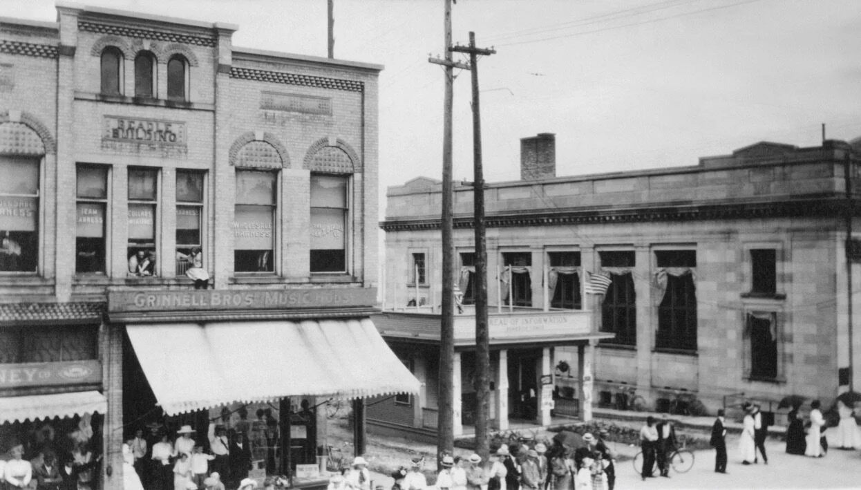 Vintage photo of Traverse City street scene circa 1910, showing Beadle Building, the Bureau of Information, and Grinnell Bros Music House